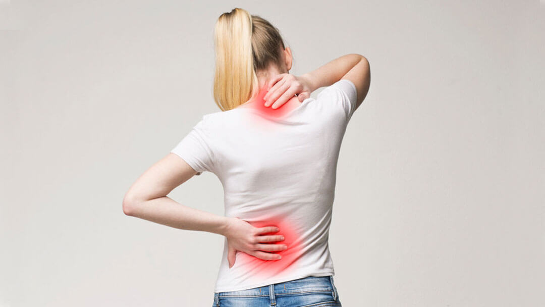 Woman in pain touching her back