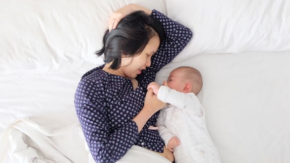 Woman with baby in bed