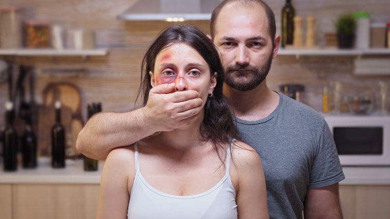 Violent man holding a woman